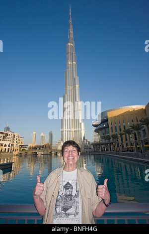 American visitor poses in front of Burj Khalifa, tallest man made structure ever built Stock Photo