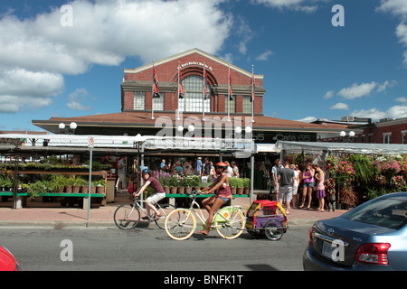 Family Cycle Towing A Child Carrier Past The Ottawa Byward Market On A Sunday Morning, Editorial Use Only Stock Photo