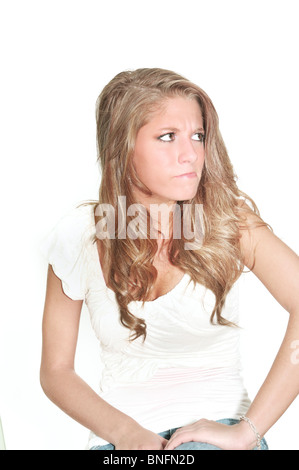 A teenage girl shows an expression of disgust or anger. High key, white background, cutout. Concepts, conceptual. USA. Stock Photo