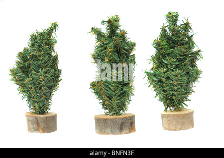 Miniature plastic christmas tree figures isolated on white background. Stock Photo