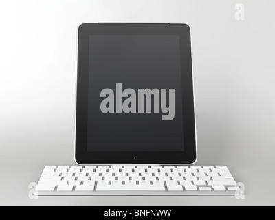 Apple iPad 3G tablet computer with a keyboard dock accessory isolated on gray background Stock Photo