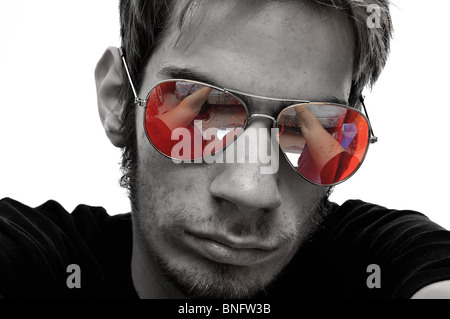 Portrait of a young man with glowing red aviator sunglasses. Stock Photo