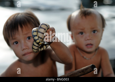 Little boys holding snakes, Tonle Sap Lake, Cambodia Stock Photo - Alamy