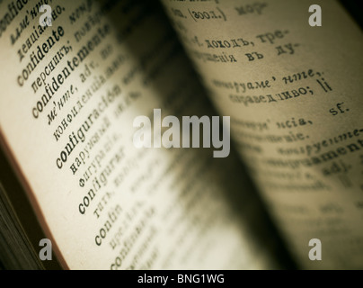 Closeup of the word 'confidentemente' with a spot light on the text. Opened old book. Stock Photo