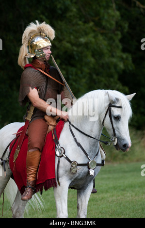 Roman Cavalry soldier on a white horse at a historical reenactment living history display Stock Photo