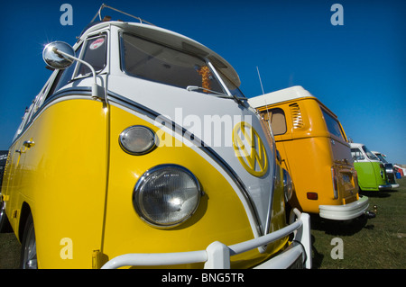 Imaculate colourful restored VW Volkswagen Kombi Campervans taking part in a rally on Brighton and Hove seafront. Stock Photo