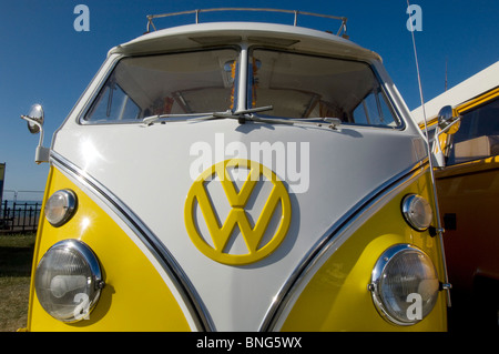 An imaculate Yellow and white restored VW Volkswagen Kombi Campervan taking part in a rally on Brighton and Hove seafront. Stock Photo