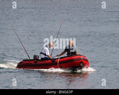 Husband and wife going fishing in a dingy, River Fowey, Cornwall, UK Stock Photo
