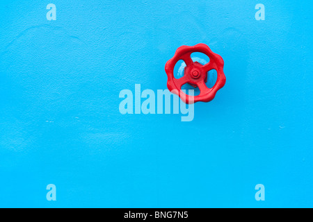 The red valve on a blue background Stock Photo
