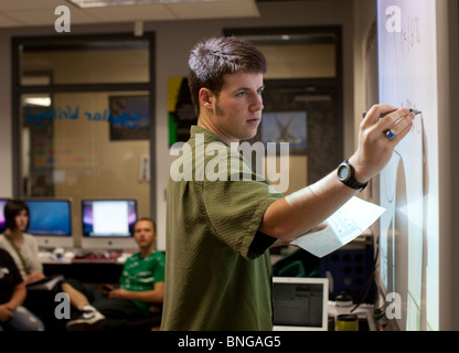 Anglo male high school student works a math problem on an interactive white board  at Manor New Tech High in Manor, Texas. Stock Photo