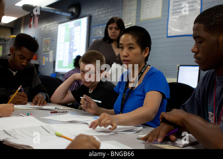 Students in physics class at Manor New Tech High School in Manor, Texas, work together with their teacher on a  class problem Stock Photo