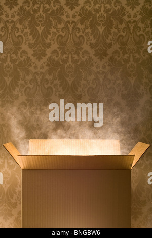 Empty cardboard box with magic dust coming out of it Stock Photo