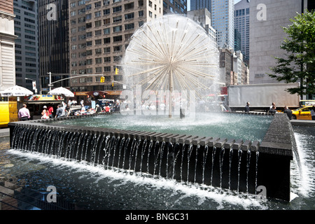dandelion fountain on Sixth Avenue in Manhattan is a refreshing sight on hot sunny summer day in New York City Stock Photo