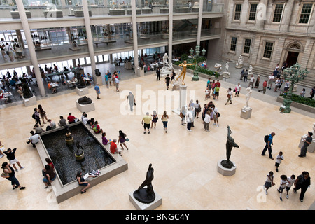 view looking down at newly reopened center court of American Wing of Metropolitan Museum of Art on crowded summer weekday NYC Stock Photo