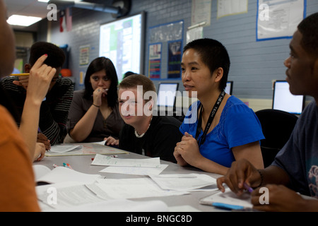Students in physics class at Manor New Tech High School in Manor, Texas, work together with their teacher on a  class problem Stock Photo