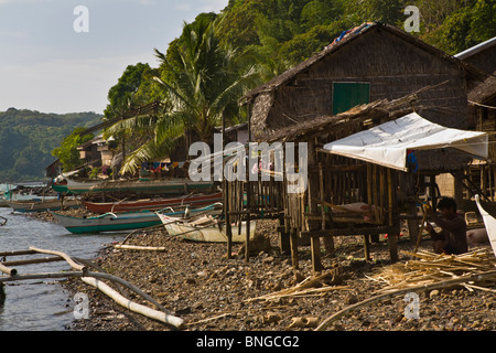 Catamarans and houses in a small fishing village north of EL NIDO - PALAWAN ISLAND, PHILIPPINES Stock Photo