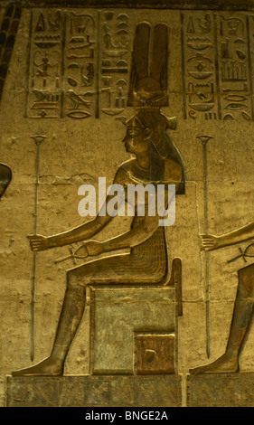 Ptolemaic temple of Hathor and Maat. Polychrome reliefs that decorate the interior. Hathor. Seated figure. Deir el-Medina. Egypt Stock Photo