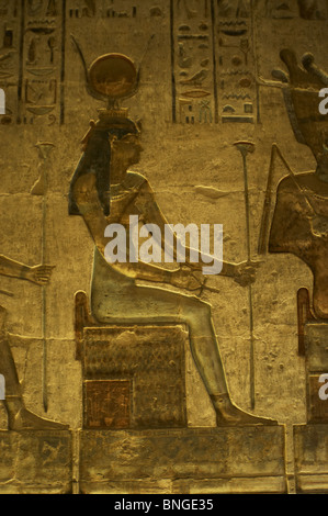 Ptolemaic temple of Hathor and Maat. Polychrome reliefs that decorate the interior. Hathor. Seated figure. Deir el-Medina. Egypt Stock Photo