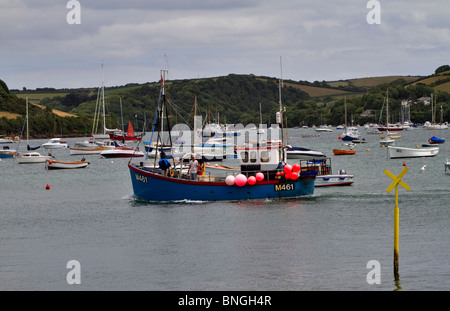 Commercial fishing boat in Salcombe Estuary. A fishing boat returns with their catch after a day's fishing. Stock Photo