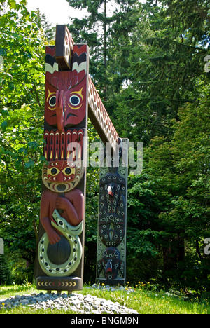 Intricately and ornately carved First Nations native design long house wooden support posts Stanley Park Vancouver BC Stock Photo