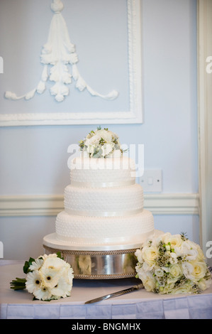 Wedding Cake and bride's floral bouquet Stock Photo