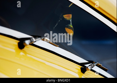 Sunglasses hanging from the rear view mirror of a yellow Ford pop drag car at the Santa Pod Retro Show 2010 Stock Photo