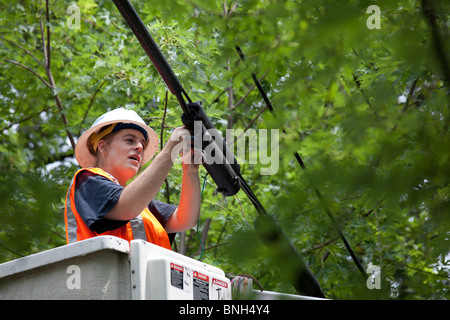 Detroit, Michigan - An AT&T telephone repair woman searches for a problem in telephone wires leading to a residence. Stock Photo
