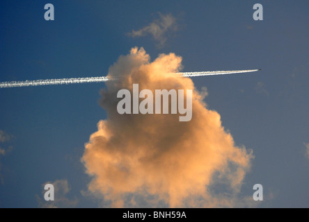 Aeroplane leaves contrails in the sky, jet plane leaving contrail Stock Photo
