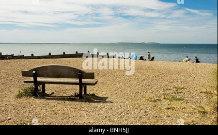 An empty bench on the shingle beach at Whitstable in Kent.  Photo by Gordon Scammell Stock Photo
