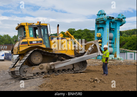 CAT D6R LPG bulldozer working on regeneration of former steelworks site in Ebbw Vale Blaenau Gwent South Wales UK Stock Photo