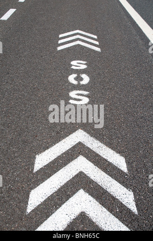 SOS sign with direction arrows on an emergency lane of a freeway Stock Photo