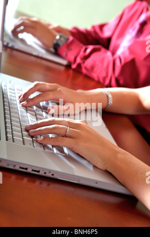 Up Close abstract of two laptops with a male and female working on them Stock Photo