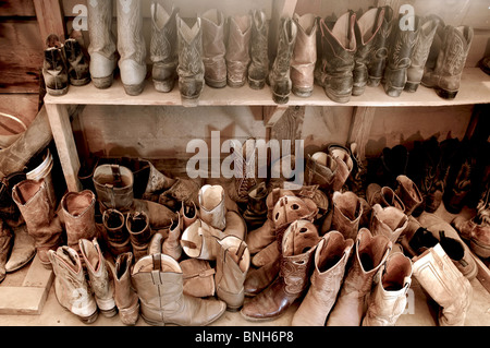 Tack Room full of Well Worn Cowboy Boots Stock Photo