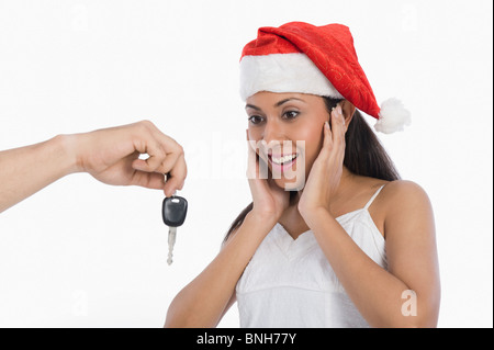 Woman surprised to see car key as a Christmas present Stock Photo