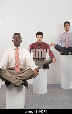 Three businessmen practicing yoga Stock Photo