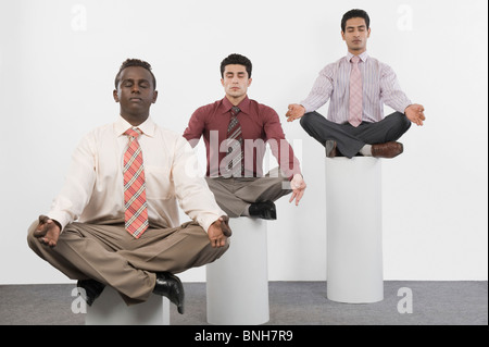 Three businessmen practicing yoga Stock Photo