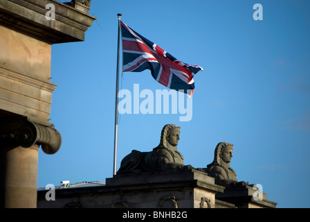 Union Jack flag flying above the Royal Scotish Academy (art gallery) at The Mound in the centre of Edinburgh, Scotland. Stock Photo