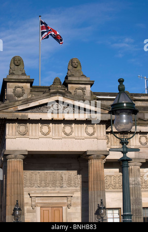 Union Jack flag flying above the Royal Scotish Academy (art gallery) at The Mound in the centre of Edinburgh, Scotland. Stock Photo