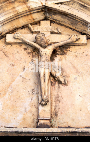 Detail of the ancient roman relief - crucified Jesus Christ - from 1342. Parish church of Saint Mark the Evangelist Stock Photo