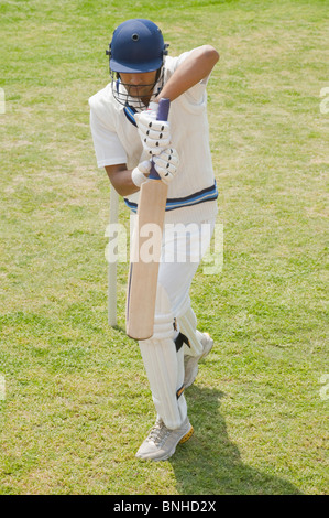 Batsman in backward defense stance Stock Photo