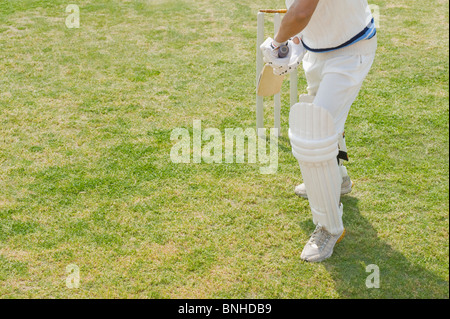 Low section view of a man standing with hands in pockets Stock Photo