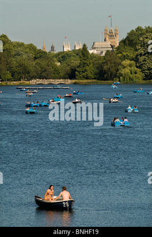 Serpentine Lake, Hyde Park central London UK Couple alone in a small for hire pleasure boat  Houses of Parliament in background. 2010 HOMER SYKES Stock Photo