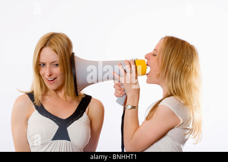 Twin Sisters Megaphone 20-30 years Acoustic Action Adult Adults Background Blond hair Bossy Communicate Communication Control Stock Photo