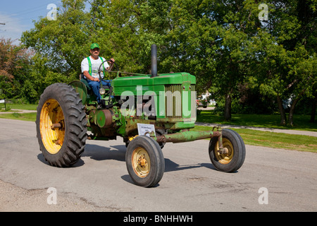 A procession of antique tractors at the 2010 Tractor Trek in Reinland, Manitoba, Canada. Stock Photo