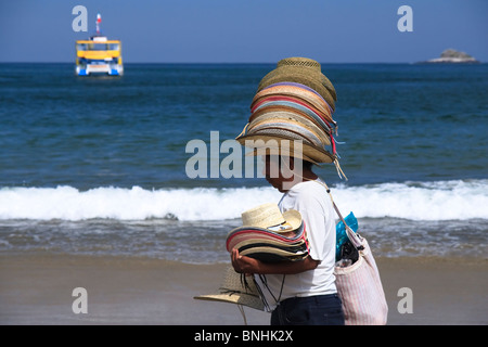 Hat vendor on the beach of Rincon de Guayabitos, Jaltemba Bay, state of Nayarit, Pacific Coast of Mexico. Stock Photo