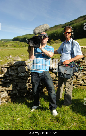 Video cameraman and sound recordist making a television programme, Wales UK Stock Photo