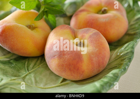 Flat peach (Prunus persica var. platycarpa) Stock Photo