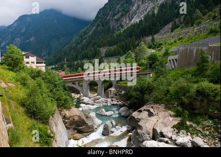 Switzerland. Travel by Train in Switzerland. Matterhorn-Gotthard bahn train running north above the Reuss River towards Altdorf Stock Photo