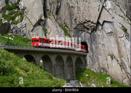 Switzerland. Travel by Train in Switzerland. The Matterhorn-Gotthard bahn train crosses above the Devil's Bridge, the Teufelsbr Stock Photo