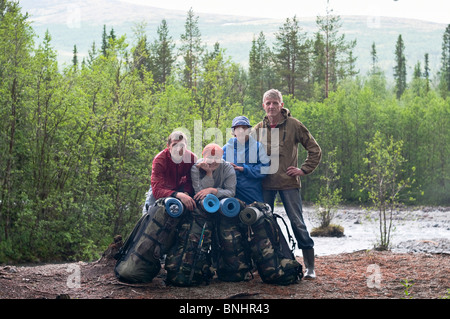 Group of travelers trekking in forest Mountaineering with knapsacks. Climbing and trekking Stock Photo